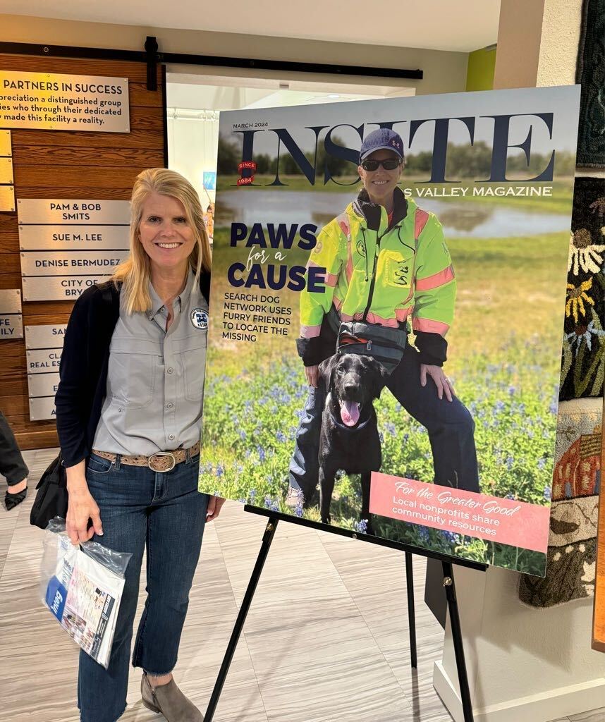 Kim poses next to a poster of the upcoming Insite magazine featuring her and K9 Seamus.